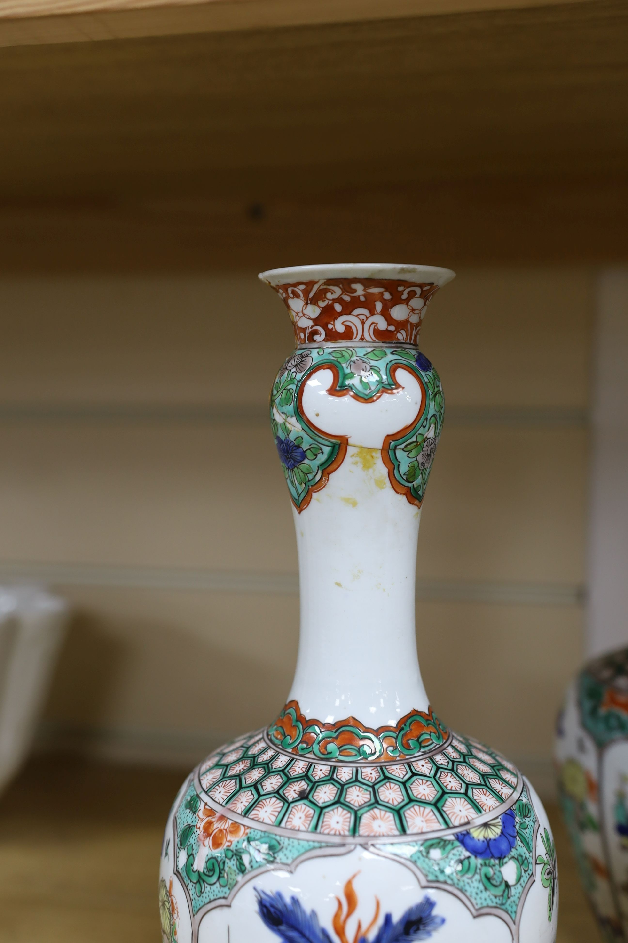 A pair Samson of Paris vases in the Chinese famille verte style and a Chinese Qianlong famille rose garlic neck vase with blue panelling motif, tallest 26cm